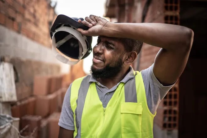 Construction Worker Wiping Sweat Away
