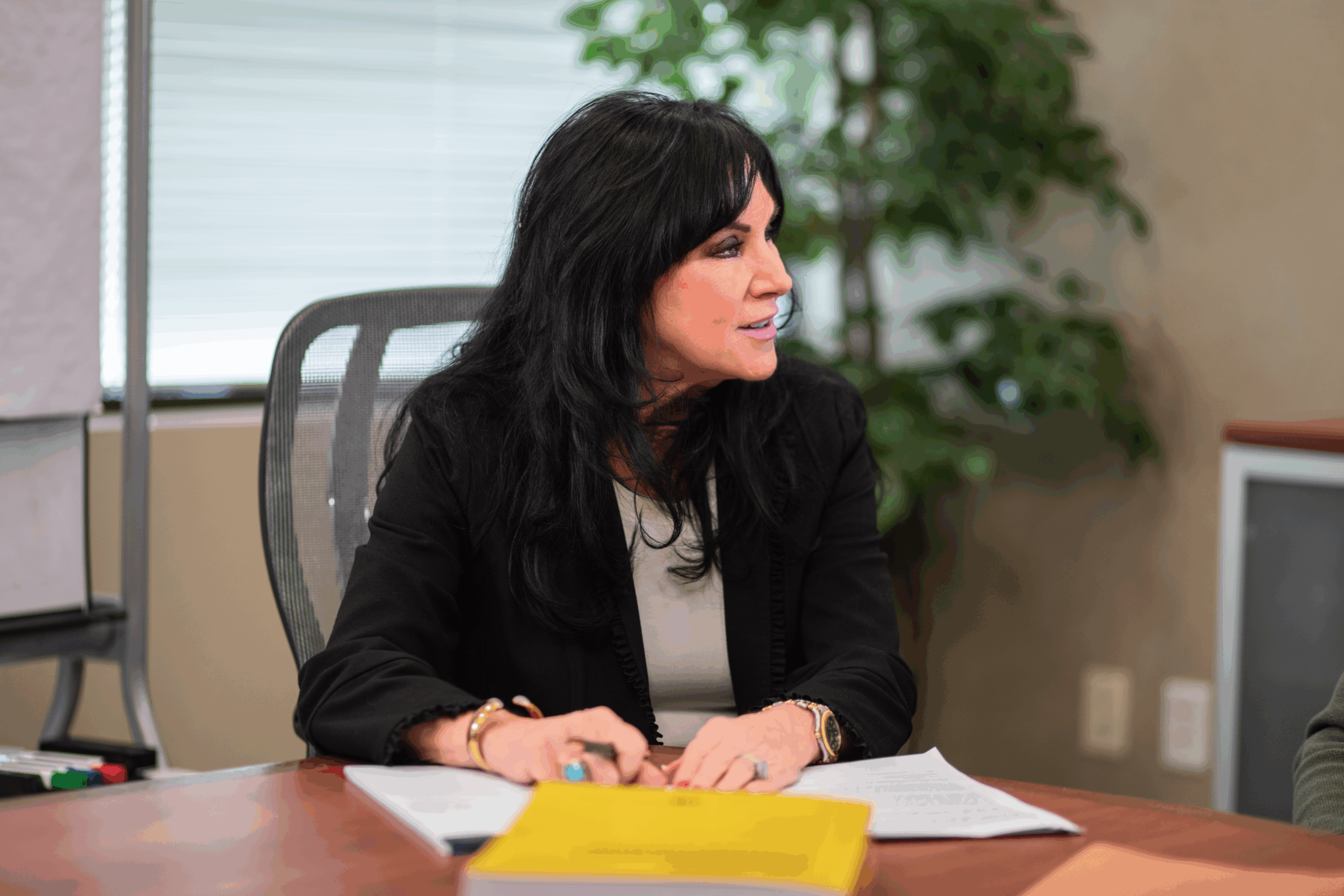Paula Robinson listening attentively during an office meeting with colleagues
