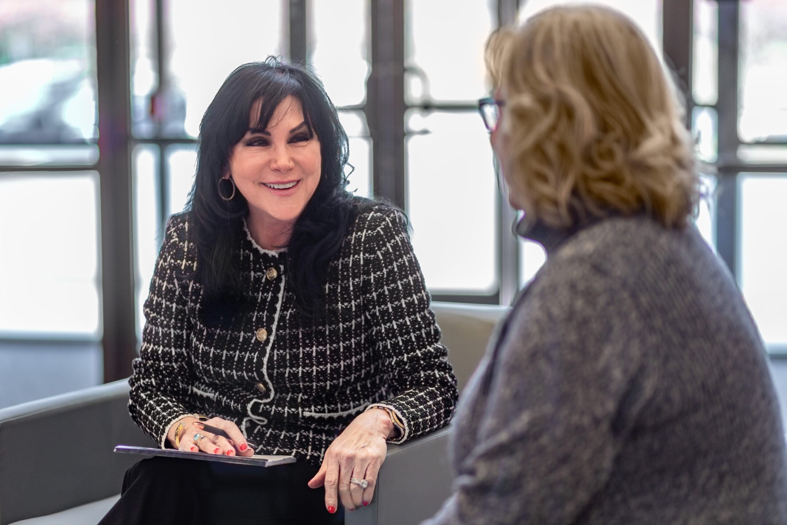 Paula Robinson smiling during a client meeting in a professional office setting